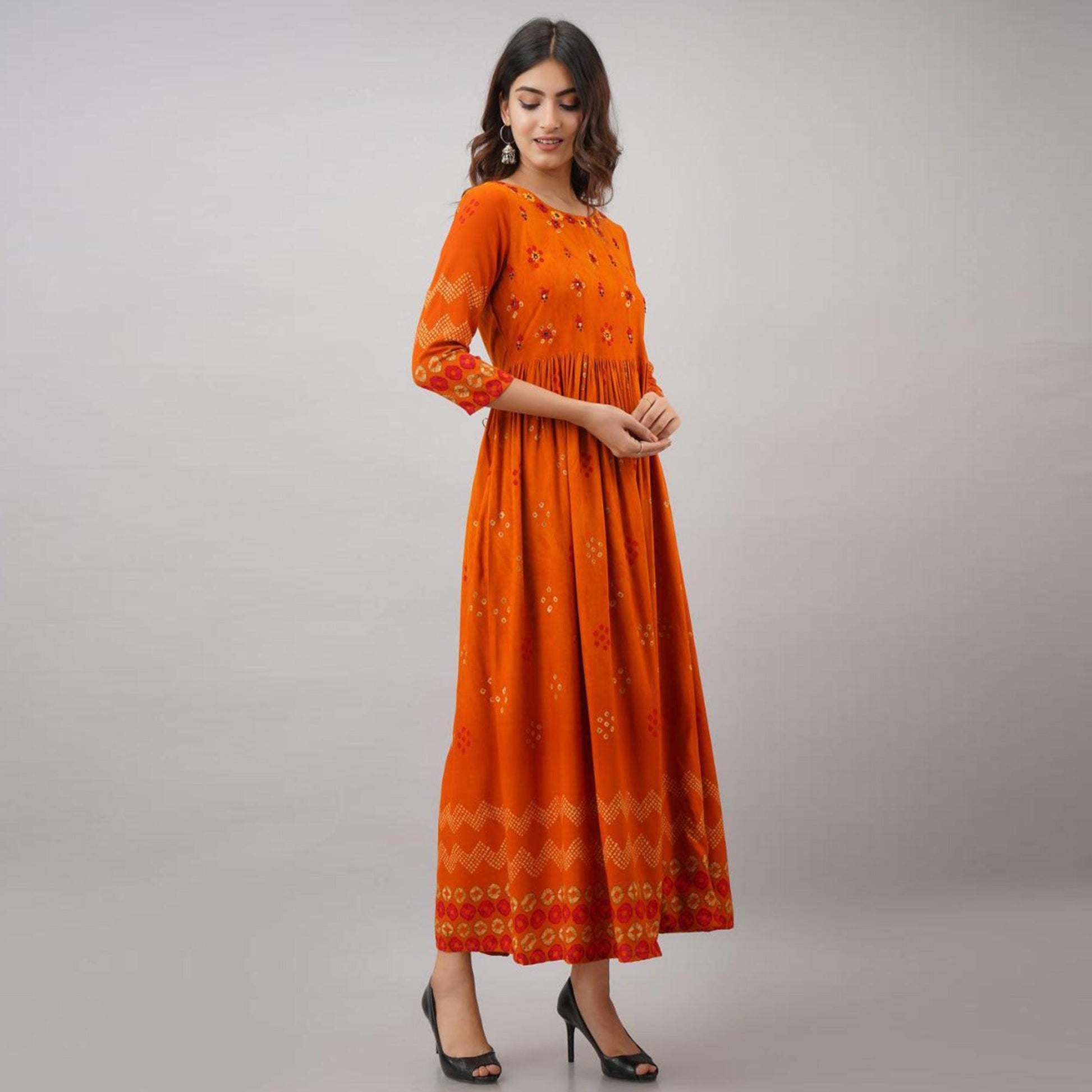 Impressive Orange Colored Partywear Embroidered Muslin Long Kurti