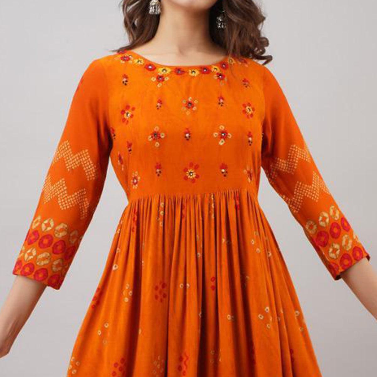 Impressive Orange Colored Partywear Embroidered Muslin Long Kurti