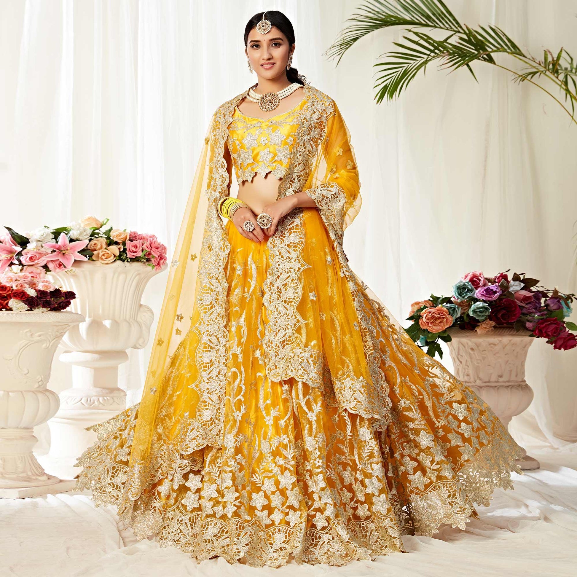 Impressive Yellow Colored Wedding Wear Embroidered Heavy Net Lehenga Choli