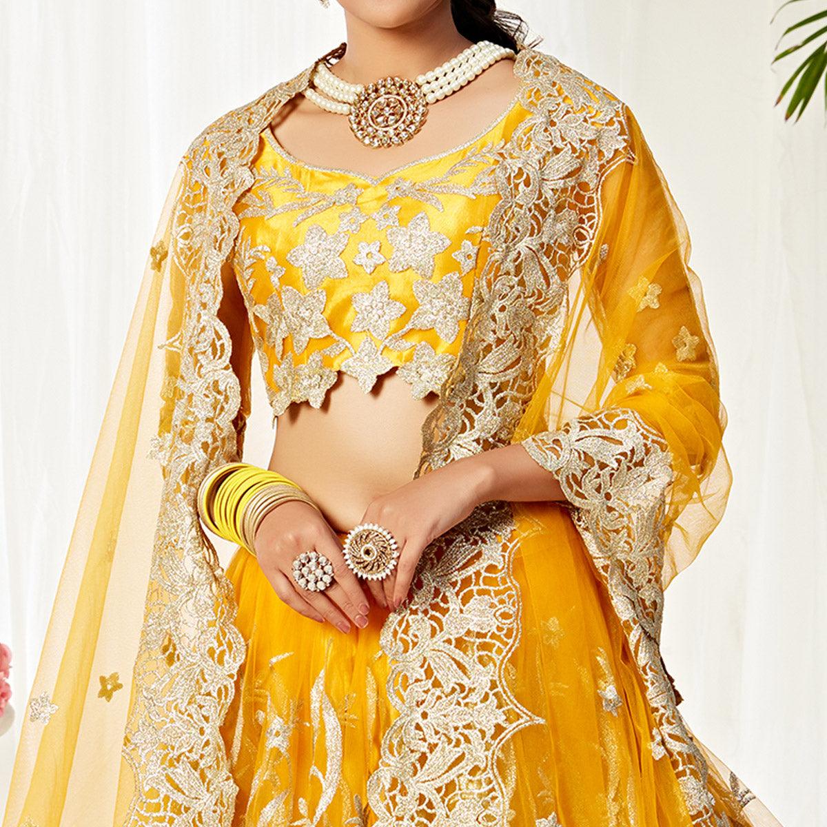 Impressive Yellow Colored Wedding Wear Embroidered Heavy Net Lehenga Choli