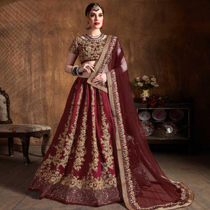Innovative Maroon Colored Wedding Wear Embroidered Raw Silk Lehenga