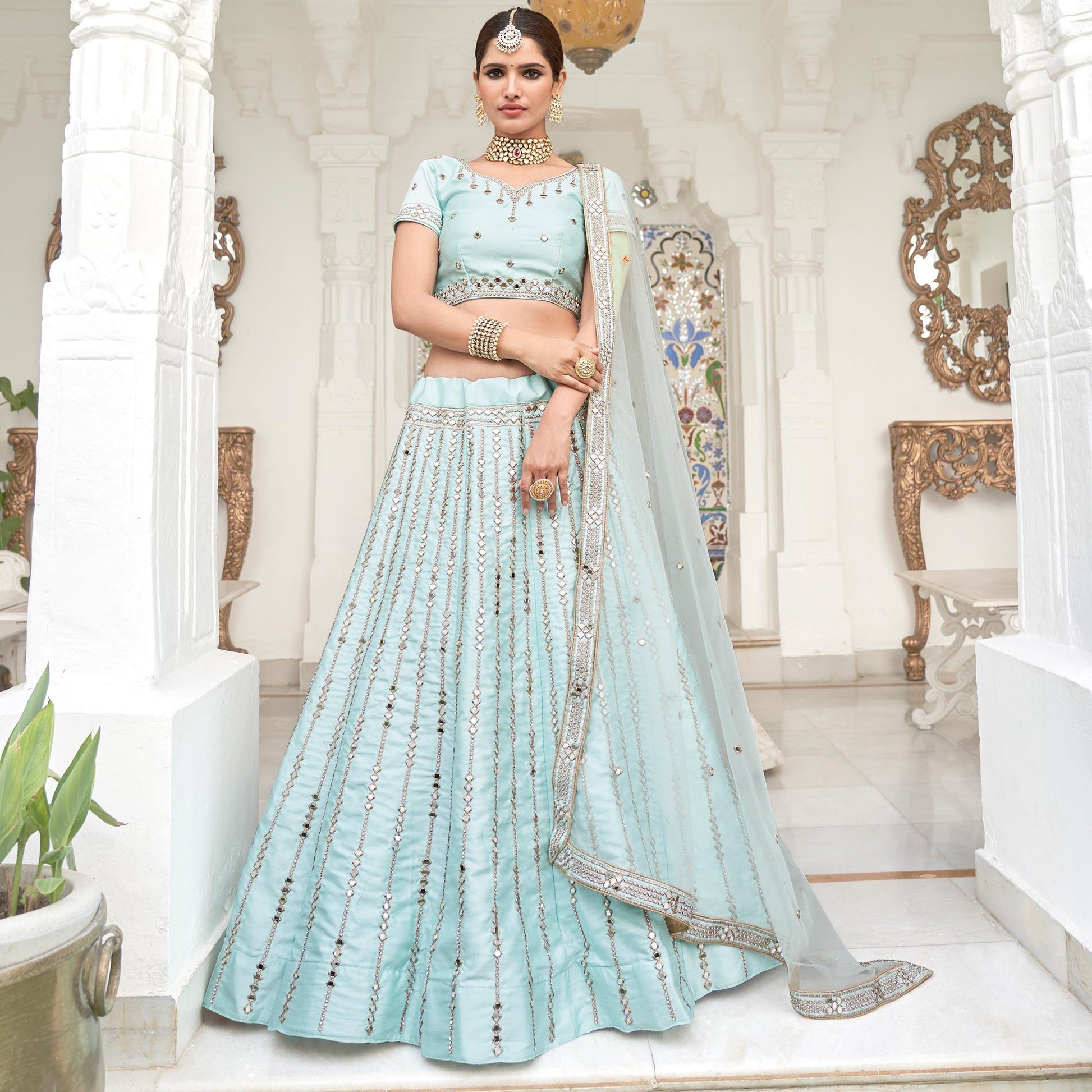 Intricate Ice Blue Coloured Wedding Wear Mirror Work Heavy Silk Lehenga Choli