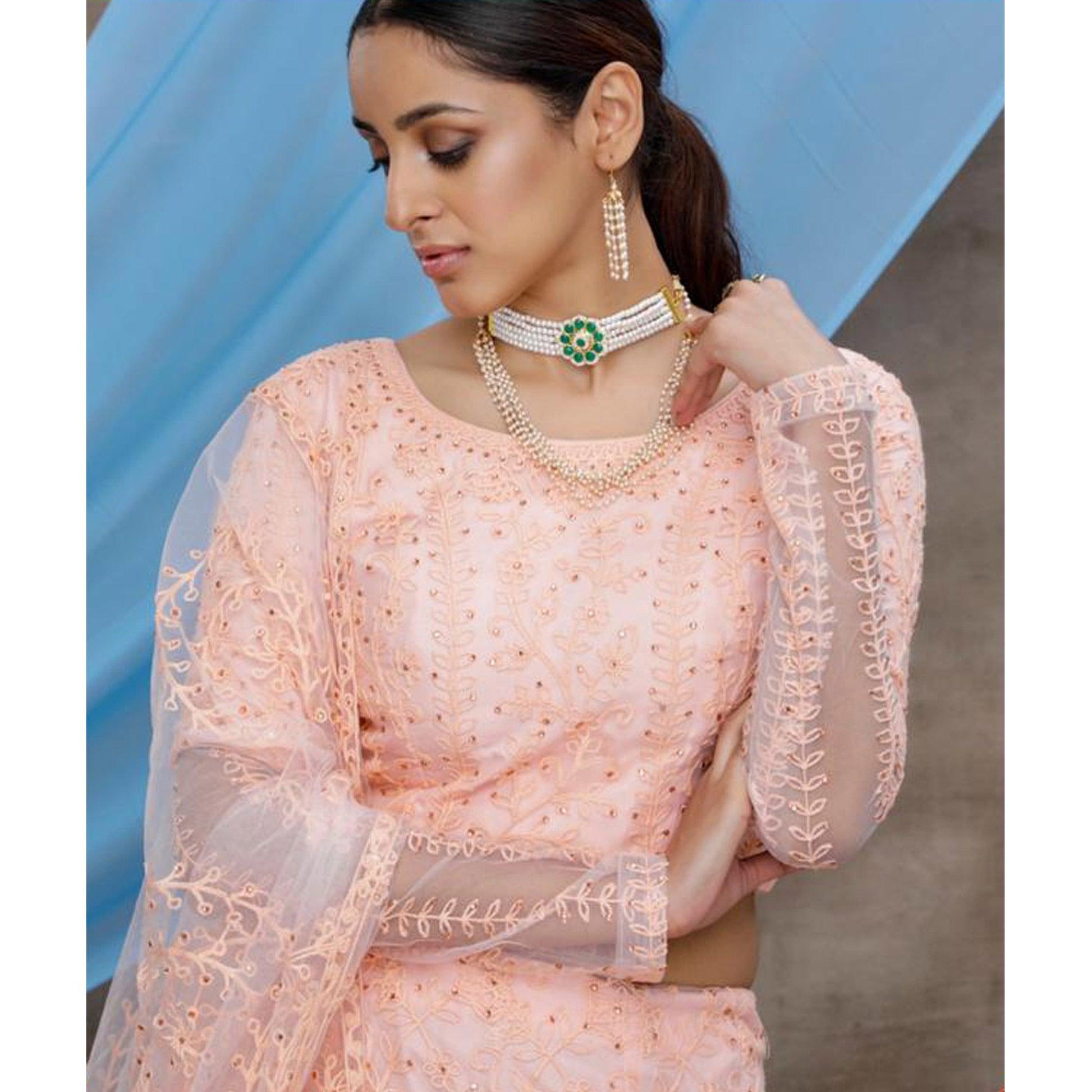 Intricate Peach Colored Party Wear Embroidered Net Lehenga Choli