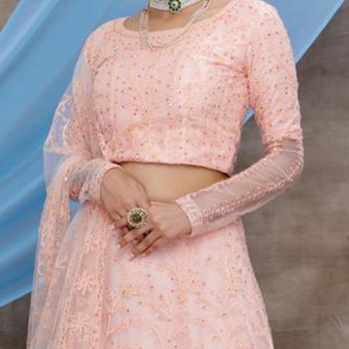 Intricate Peach Colored Party Wear Embroidered Net Lehenga Choli