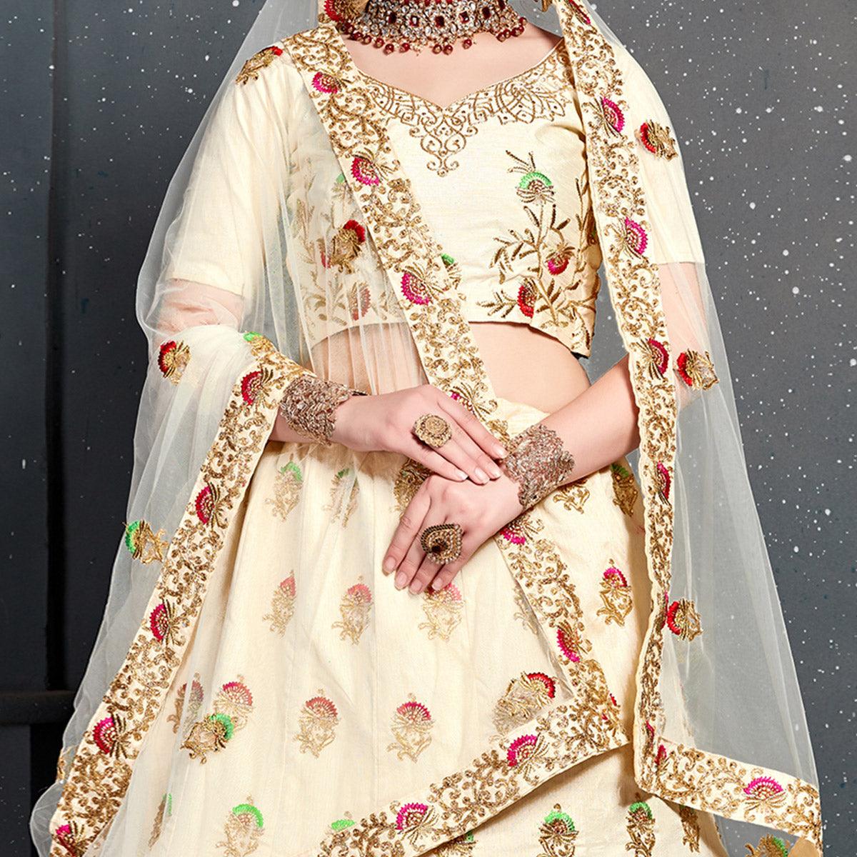 Magnetic Cream Colored Wedding Wear Embroidered Silk Lehenga Choli