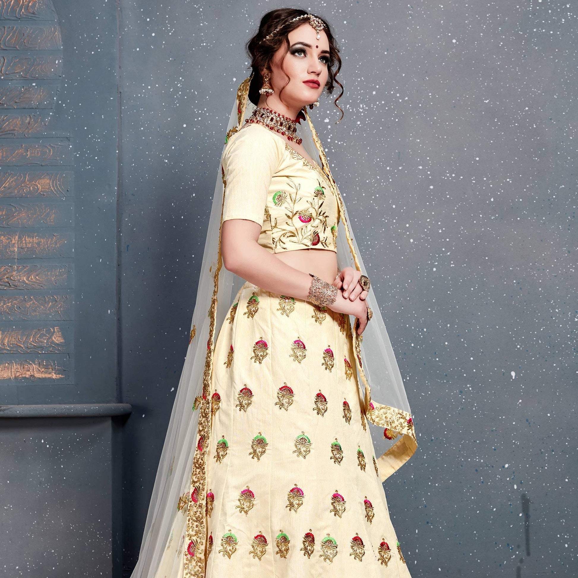 Magnetic Cream Colored Wedding Wear Embroidered Silk Lehenga Choli