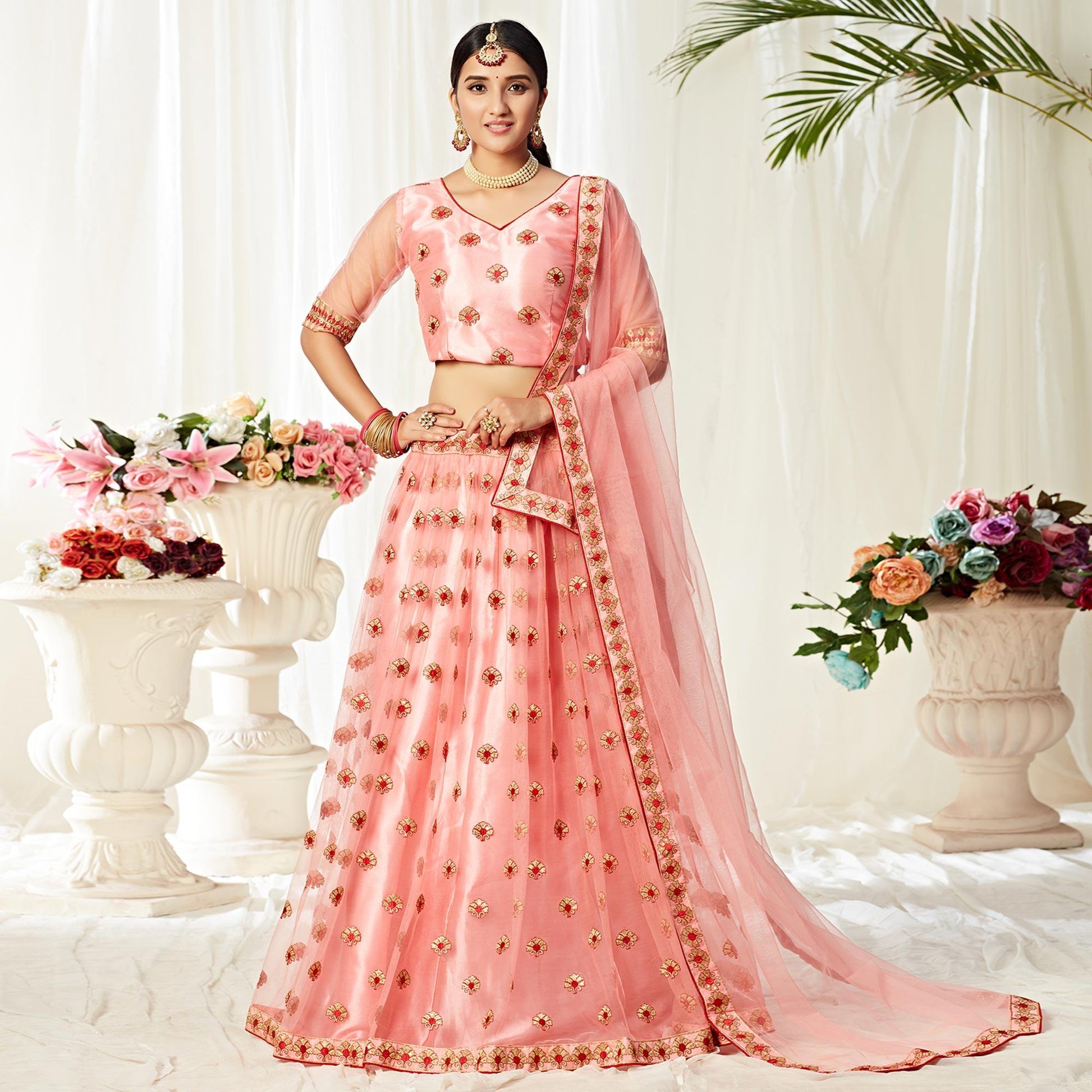 Majesty Peach Colored Wedding Wear Embroidered Heavy Net Lehenga Choli