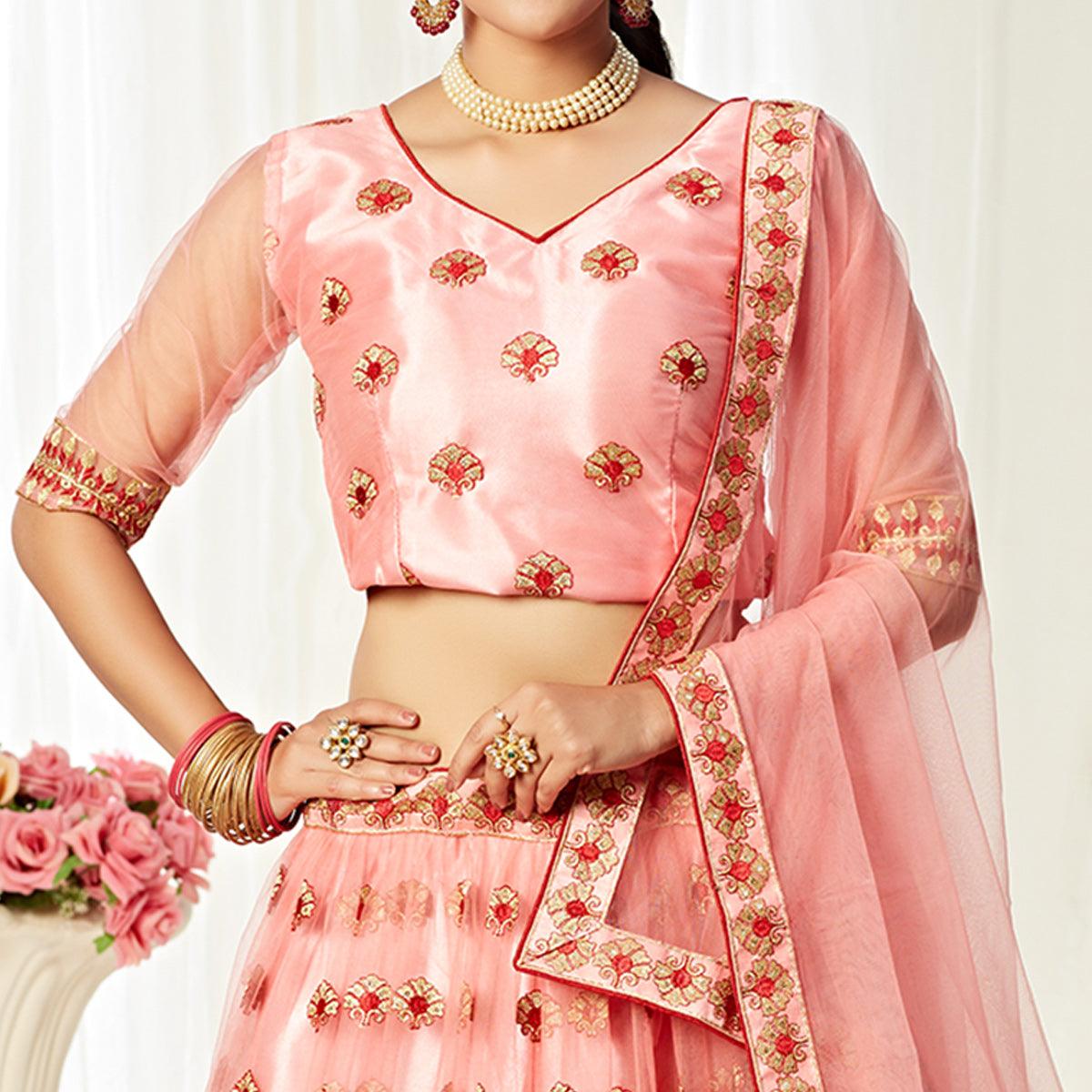 Majesty Peach Colored Wedding Wear Embroidered Heavy Net Lehenga Choli