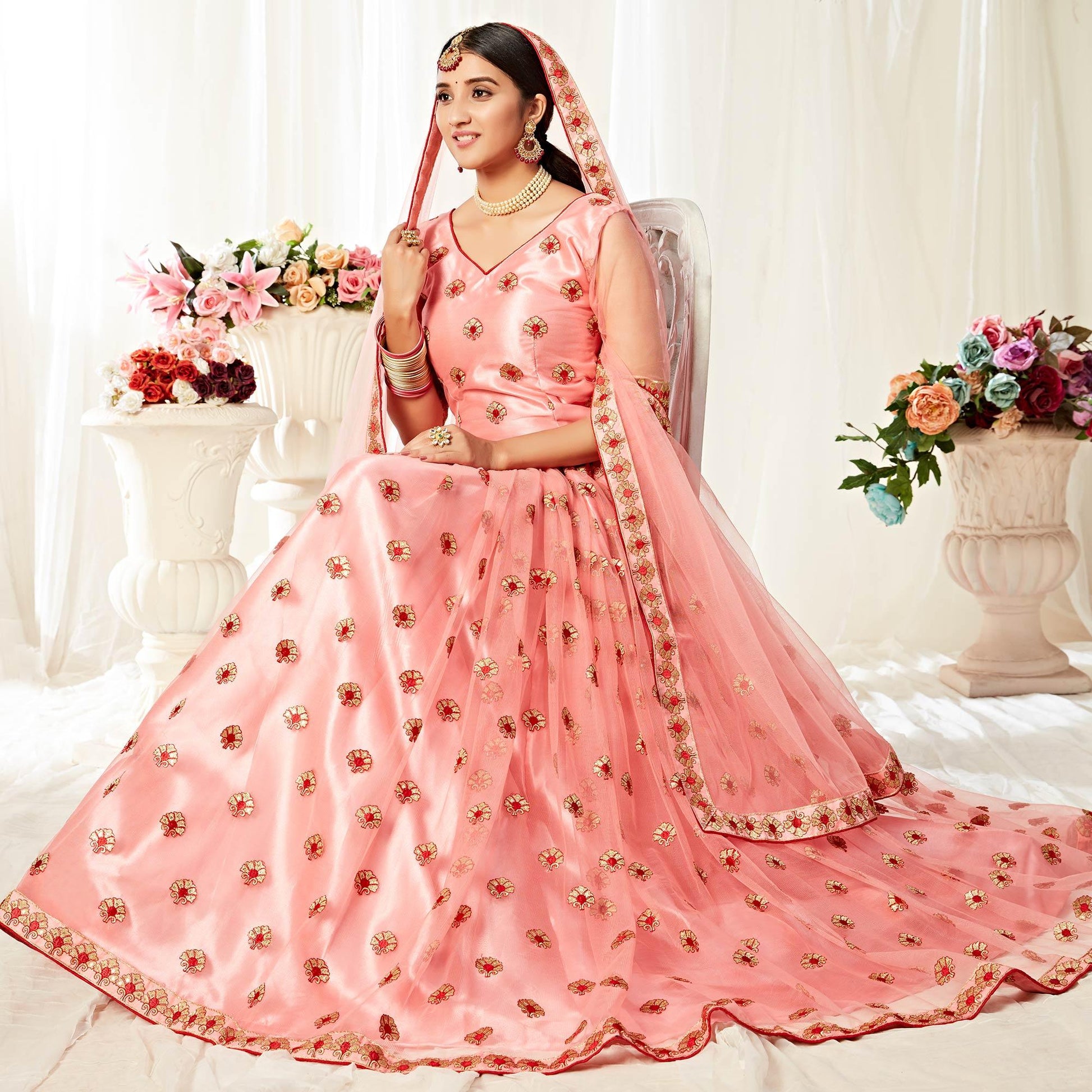 Majesty Peach Colored Wedding Wear Embroidered Heavy Net Lehenga Choli
